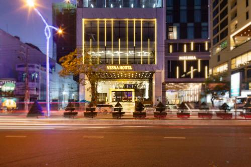 a city street at night with a building with lights at Vesna Hotel Nha Trang in Nha Trang