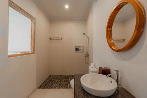 a bathroom with a sink and a mirror at Sakya Villa Canggu By Bali Cabin in Canggu