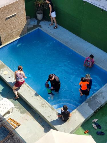 a group of people in a swimming pool at HOSTAL SAN MARINO in Manta