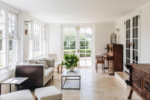 a living room with a couch and a table at Daisy Hill Southern Highlands in Moss Vale