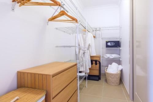 a dressing room with a desk and a closet at Private Luxury Haven with SUV Hire, Pool, Near Marina in Trinity Beach