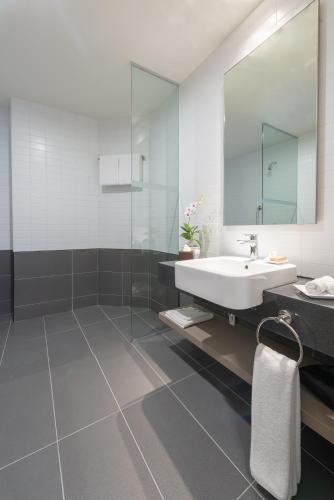 a bathroom with a sink and a mirror at Hilton Garden Inn Kuala Lumpur - South in Kuala Lumpur