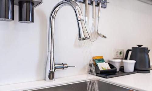 a kitchen sink with a chrome kitchen faucet at Allzip Archieve4H Residence hotel Busan in Busan