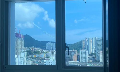 a view of a city from a window at Allzip Archieve4H Residence hotel Busan in Busan