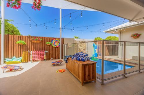 a backyard with a pool and a play area at Private Luxury Haven with SUV Hire, Pool, Near Marina in Trinity Beach
