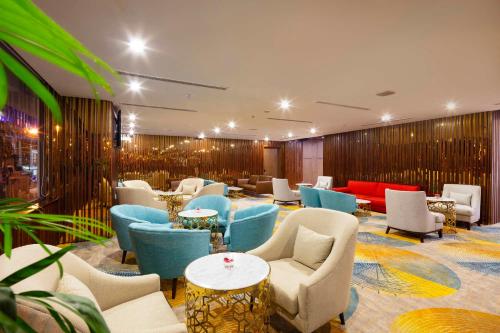 a hotel lobby with chairs and tables at Vesna Hotel Nha Trang in Nha Trang