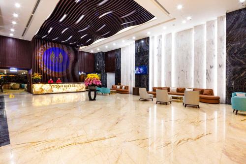 a lobby with couches and chairs in a building at Vesna Hotel Nha Trang in Nha Trang