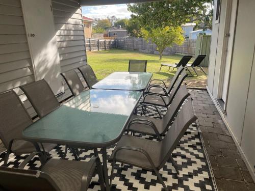 a glass table and chairs on a patio at The Sabble Shak in Capel Sound