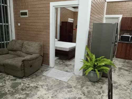 a living room with a couch and a bathroom at Villa Shendel in Gampaha