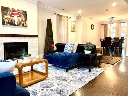 a living room with a blue couch and a fireplace at 5 Bedroom Huge House in Best Location Parking Fireplace Back Yard in Chicago