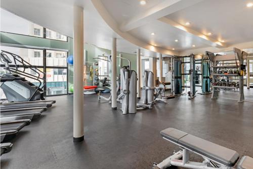a gym with a lot of treadmills and machines at Modern Comfort in LA Free Parking&10 Min To Cedars in Los Angeles