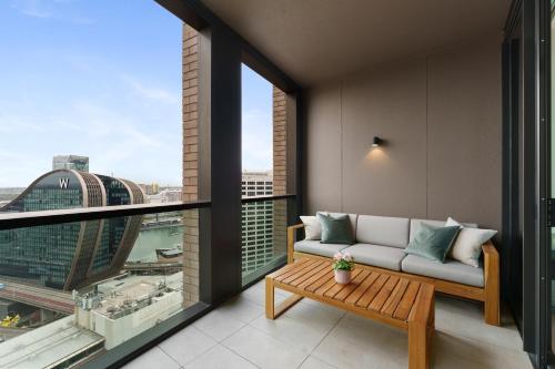 a living room with a couch and a large window at Harbour Views, Fireworks & Secure Parking in Sydney