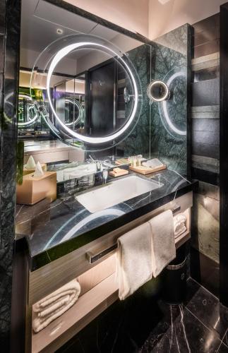 a bathroom with a large sink and a mirror at DoubleTree by Hilton Putrajaya Lakeside in Putrajaya