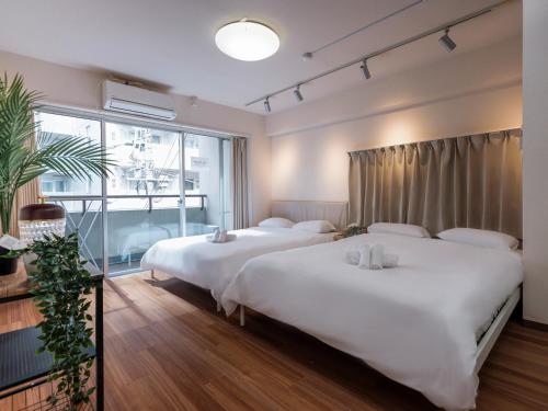 a hotel room with two beds and a window at Tokyo Stay Akasaka in Tokyo