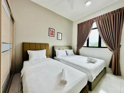 a bedroom with two beds and a window at New The Sun Homestay at Sg Nibong nearby Queensbay or PISA or FTZ Bayan Lepas HENG in Bayan Lepas