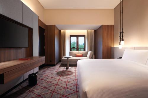 a hotel room with a bed and a television at DoubleTree by Hilton Putrajaya Lakeside in Putrajaya