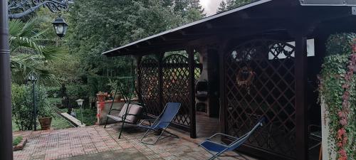 two chairs sitting on a patio with a gazebo at Etna Garden Francesca in Presa