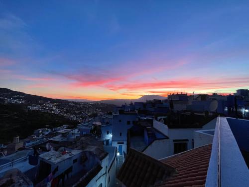 a view of a city at sunset at Dar Fatima in Chefchaouene