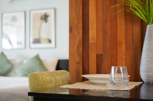 a table with a bowl and a vase on it at Davina Beach Homes in Panwa Beach