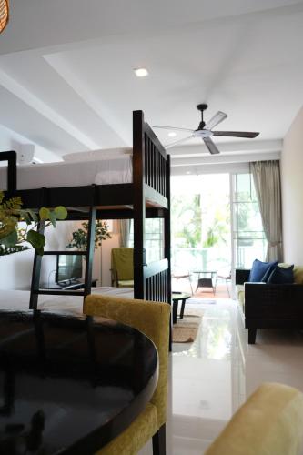 a room with a bunk bed and a living room at Davina Beach Homes in Panwa Beach