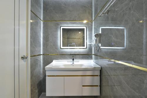 a bathroom with a sink and a mirror at Berich Hotel in Tak