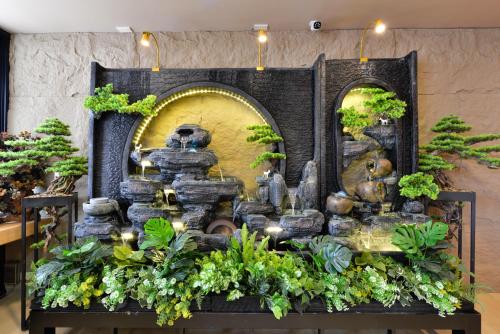 a display of a bonsai garden in a store at Berich Hotel in Tak