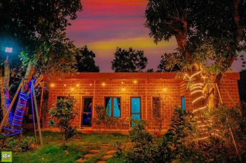 a brick house with lights on it at night at Rafe Garden-Homestay Ba Vì in Ba Vì