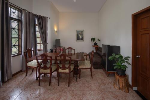 a dining room with a table and chairs at Sinabung Hills Berastagi in Berastagi