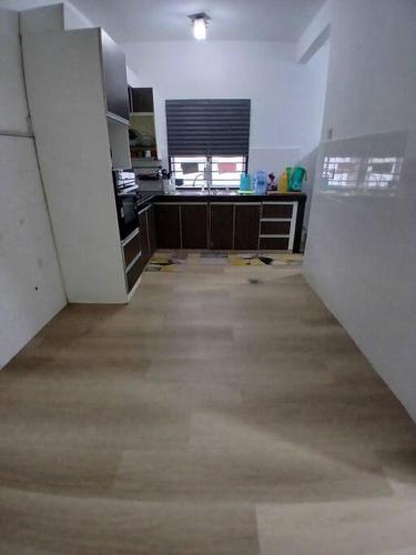 an empty room with a kitchen and a room with at Homestay Bandar Kajang in Kajang