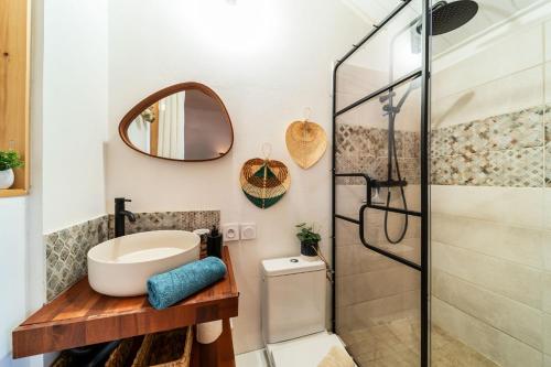 a bathroom with a sink and a shower at Les Baroudeurs Hostel in Saint-Pierre