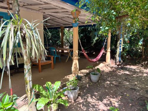 a patio with a hammock and a table with plants at Gioia House in Weligama