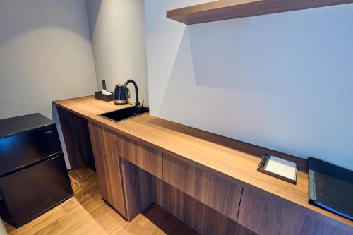 a kitchen with a sink and a large screen at ICHIFUJI Ryokan in Hitoyoshi
