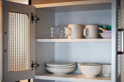 a shelf with bowls and other dishes on it at STARGAZE in Ōdōri