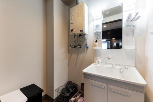 a bathroom with a sink and a mirror at STARGAZE in Ōdōri