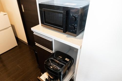 a microwave oven sitting on top of a counter at STARGAZE in Ōdōri