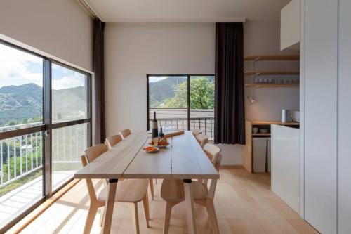 a kitchen and dining room with a table and chairs at The Villas atami amazing ocean view in Taga