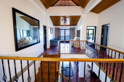 a hallway of a home with a spiral staircase at Out of the Blue Resort in Puerto Galera