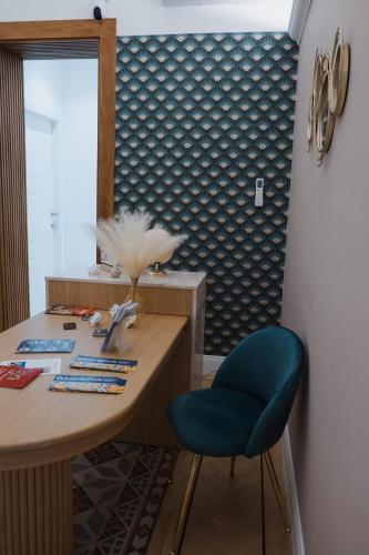 a desk with a blue chair in a room at Butera 505-Luxury Suites in Bagheria