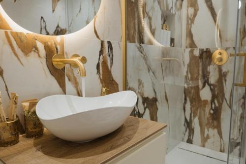 a bathroom with a white bowl sink on a counter at Butera 505-Luxury Suites in Bagheria