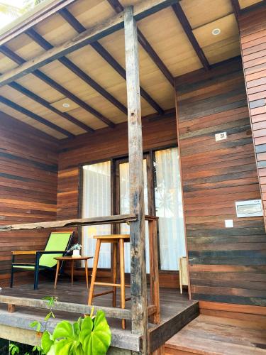 a porch of a house with wooden walls at Villa So Long Banyuwangi - Ijen in Banyuwangi