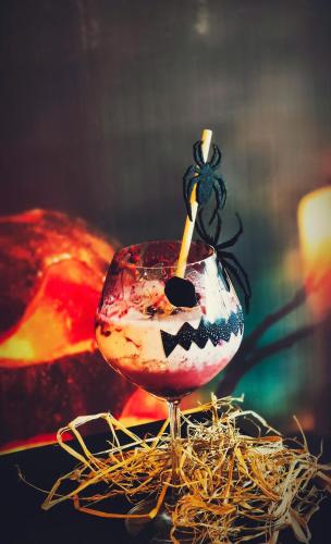 a wine glass with a candle in it sitting on some straw at Bellerive Hoi An Resort and Spa in Hoi An