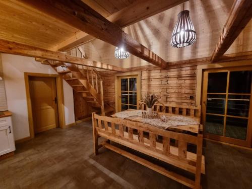 a large room with a table and a wooden wall at Bacmańska Chata z pięknym widokiem przy szlaku jacuzzi Beskidy in Złatna