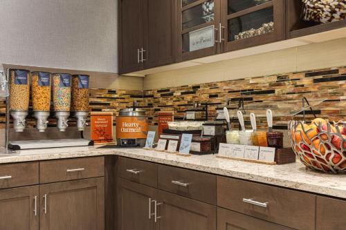 a kitchen with a counter with some food on it at Homewood Suites by Hilton - Charlottesville in Charlottesville