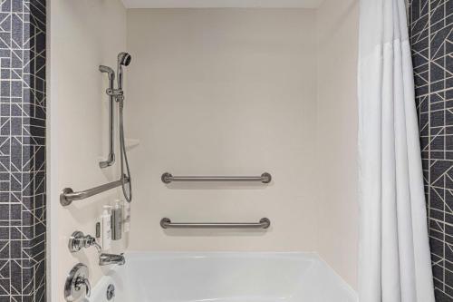 a bathroom with a tub and a shower stall at Homewood Suites by Hilton - Charlottesville in Charlottesville