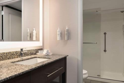 a bathroom with a sink and a shower at Homewood Suites by Hilton - Charlottesville in Charlottesville