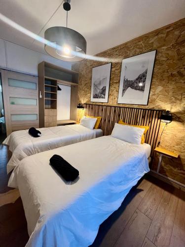 two beds in a hotel room with two bedsvisor at Lelaleu in Saint-Leu