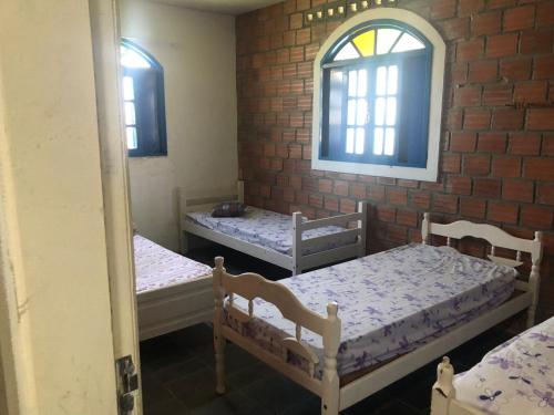 a room with two beds and a window at Casa de Praia em Itamaracá in Vila Velha