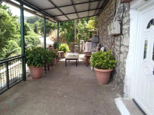 a patio with potted plants on the side of a building at Kallistws House in Zigovístion
