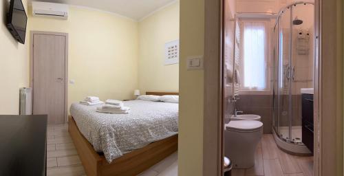a small bathroom with a bed and a shower at Casina dei Gemelli in Rome