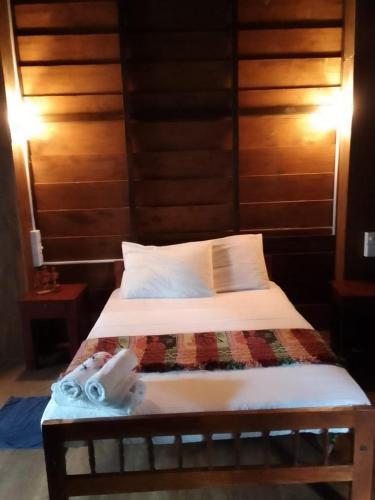 a bed in a room with two towels on it at The Cinnamon Farm Wooden Cabana Unawatuna in Unawatuna